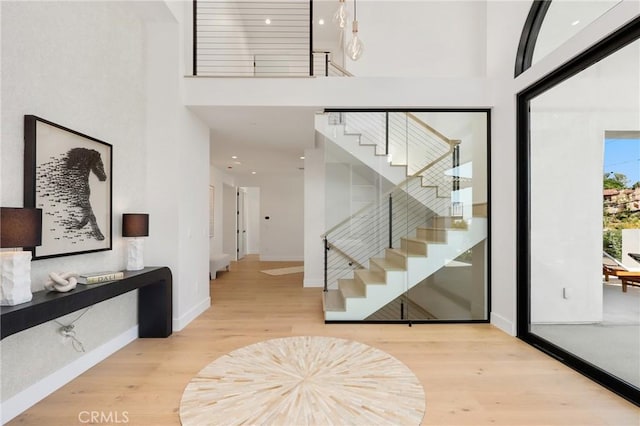 19031 Fowler Ave, North Tustin, CA 92705 - entryway featuring wood finished floors, stairs, and a towering ceiling
