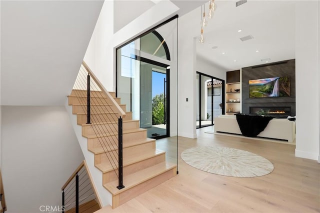19031 Fowler Ave, North Tustin, CA 92705 - foyer entrance featuring wood finished floors, a fireplace, stairs, and recessed lighting