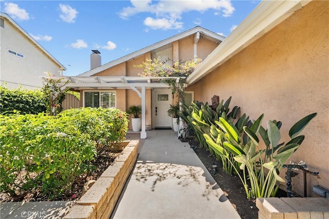 27814 Caraway Ln, Saugus, CA 91350 - doorway to property featuring stucco siding, a pergola, and a patio