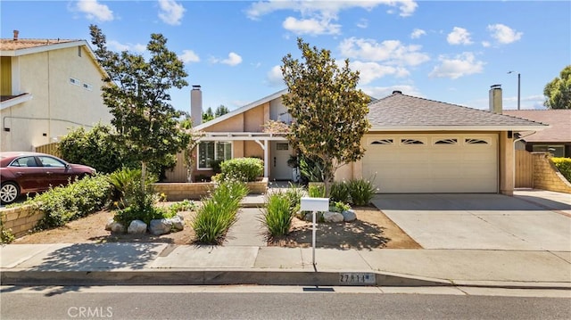 27814 Caraway Ln, Saugus, CA 91350 - view of front of property featuring an attached garage, driveway, and a chimney