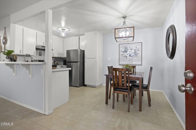 1300 Saratoga Ave Unit 306, Ventura, CA 93003 - dining area featuring a chandelier and light tile patterned floors
