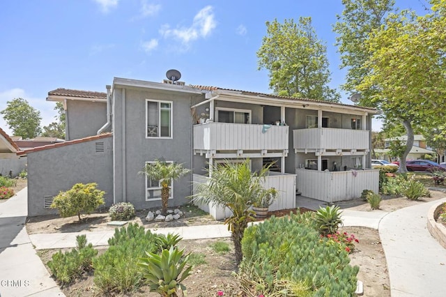 1300 Saratoga Ave Unit 306, Ventura, CA 93003 - view of front of property with stucco siding, a balcony, and a tile roof