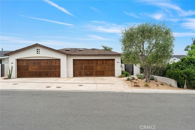 444 Morning Canyon Rd, Corona Del Mar, CA 92625 - view of front of home with stucco siding, an attached garage, and driveway