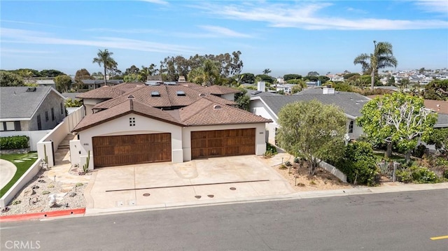 444 Morning Canyon Rd, Corona Del Mar, CA 92625 - mediterranean / spanish-style house featuring stucco siding, a garage, concrete driveway, and a residential view