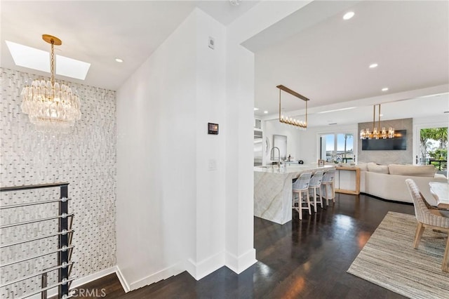 444 Morning Canyon Rd, Corona Del Mar, CA 92625 - hall featuring a chandelier, recessed lighting, dark wood-style flooring, and an accent wall