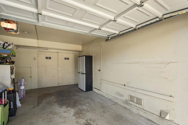9847 Mission Vega Rd Unit 3, Santee, CA 92071 - garage with a garage door opener and freestanding refrigerator