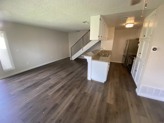 9847 Mission Vega Rd Unit 3, Santee, CA 92071 - kitchen featuring white cabinets, dark wood finished floors, a textured ceiling, freestanding refrigerator, and light stone counters
