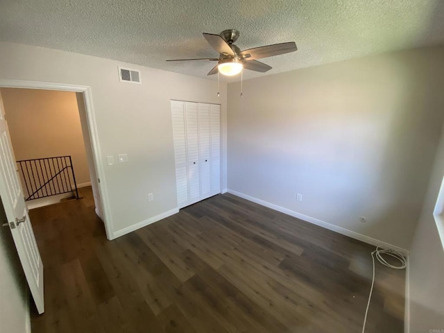 9847 Mission Vega Rd Unit 3, Santee, CA 92071 - unfurnished bedroom with dark wood finished floors, a textured ceiling, a closet, and a ceiling fan