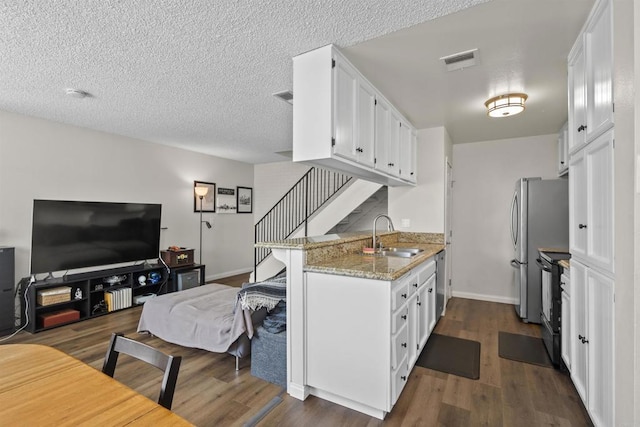 9847 Mission Vega Rd Unit 3, Santee, CA 92071 - kitchen featuring open floor plan, dark wood-type flooring, stainless steel appliances, white cabinets, and light stone counters