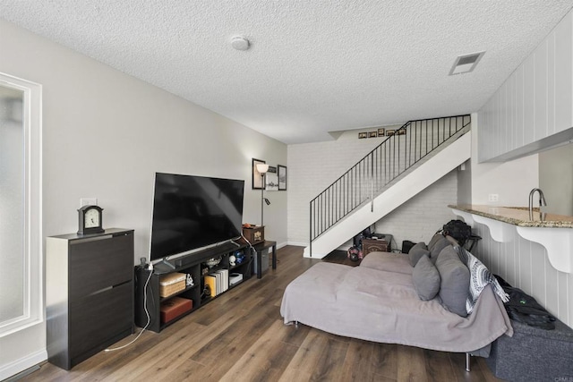 9847 Mission Vega Rd Unit 3, Santee, CA 92071 - living room with wood finished floors, stairway, and a textured ceiling