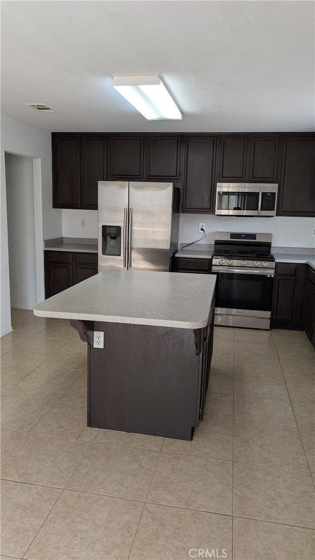 1679 Stoneside Dr, Hemet, CA 92545 - kitchen with stainless steel appliances, a kitchen island, and light tile patterned floors