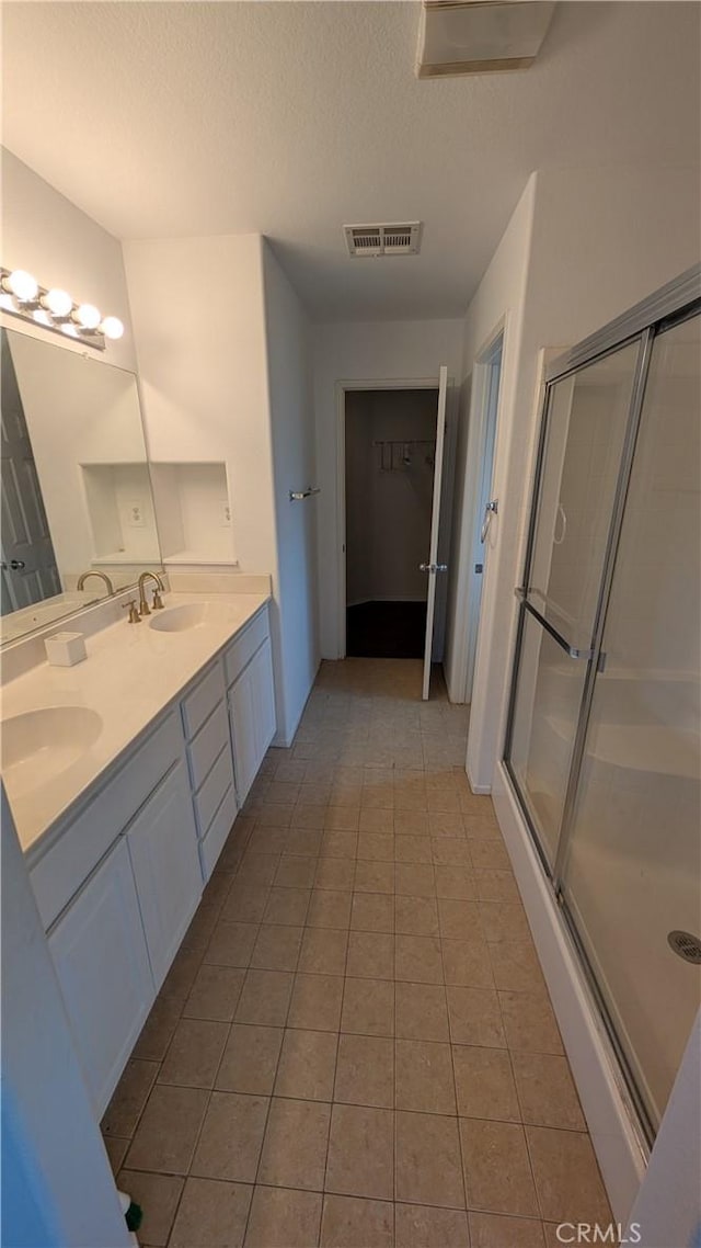 1679 Stoneside Dr, Hemet, CA 92545 - full bath with double vanity, a stall shower, tile patterned floors, and a textured ceiling
