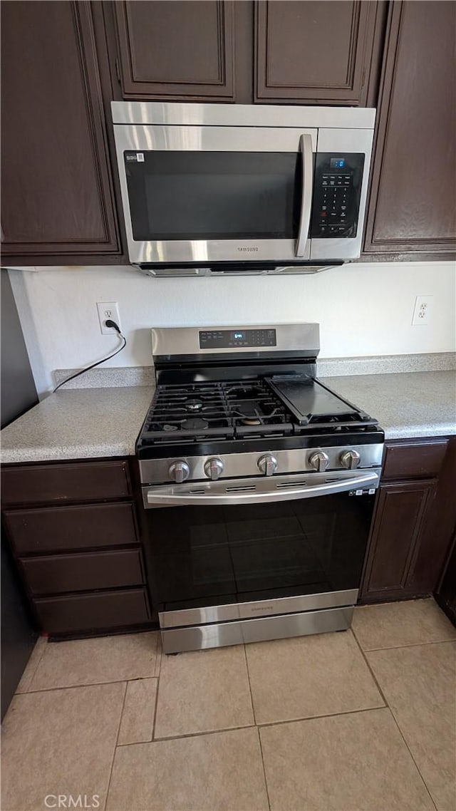 1679 Stoneside Dr, Hemet, CA 92545 - kitchen featuring stainless steel appliances, dark brown cabinets, light countertops, and light tile patterned flooring