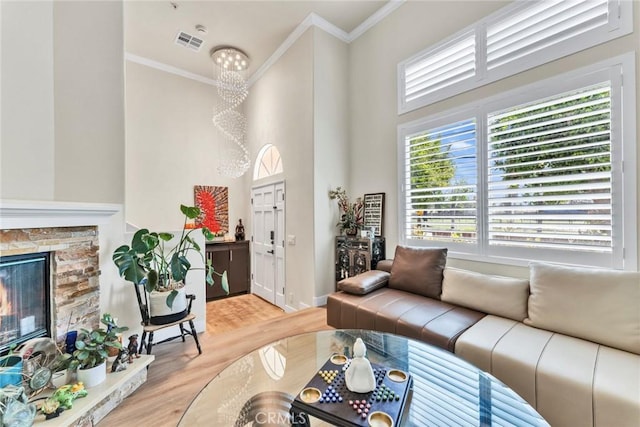 166 Alta St Unit B, Arcadia, CA 91006 - living room featuring ornamental molding, light wood-type flooring, a stone fireplace, and a high ceiling