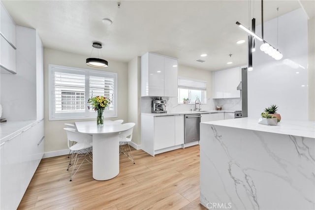 166 Alta St Unit B, Arcadia, CA 91006 - kitchen with stainless steel dishwasher, modern cabinets, white cabinetry, light wood finished floors, and pendant lighting