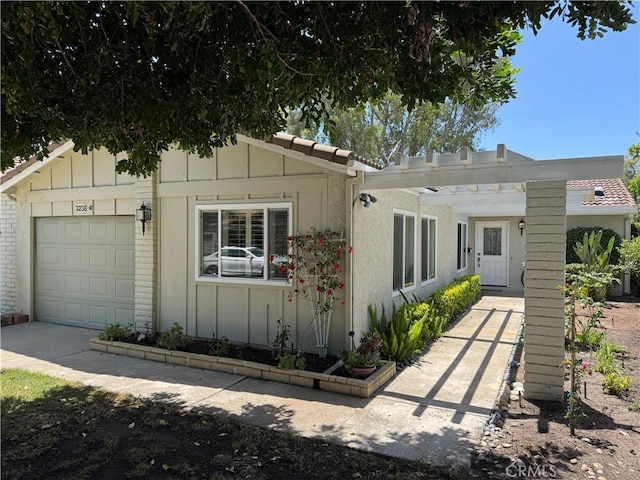 3238 San Amadeo Unit C, Laguna Woods, CA 92637 - view of front of home featuring board and batten siding and a garage