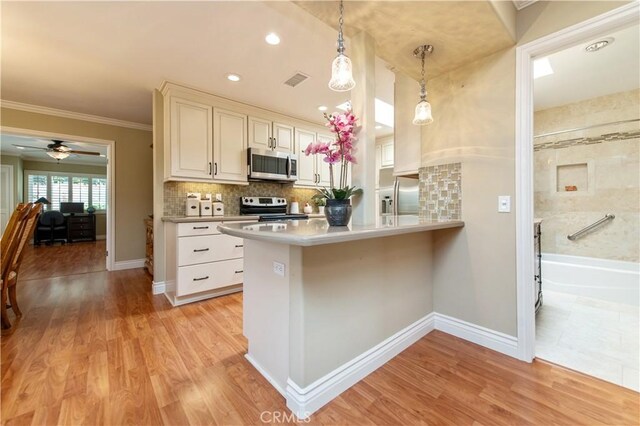 3238 San Amadeo Unit C, Laguna Woods, CA 92637 - kitchen featuring appliances with stainless steel finishes, pendant lighting, a peninsula, light countertops, and ceiling fan