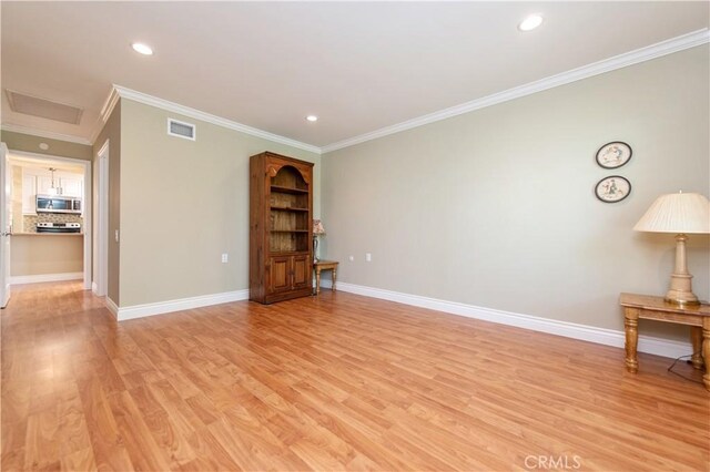 3238 San Amadeo Unit C, Laguna Woods, CA 92637 - unfurnished room with light wood-style floors, crown molding, recessed lighting, and attic access