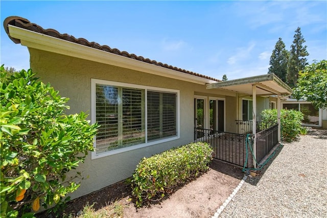 3238 San Amadeo Unit C, Laguna Woods, CA 92637 - rear view of property with stucco siding and a tiled roof