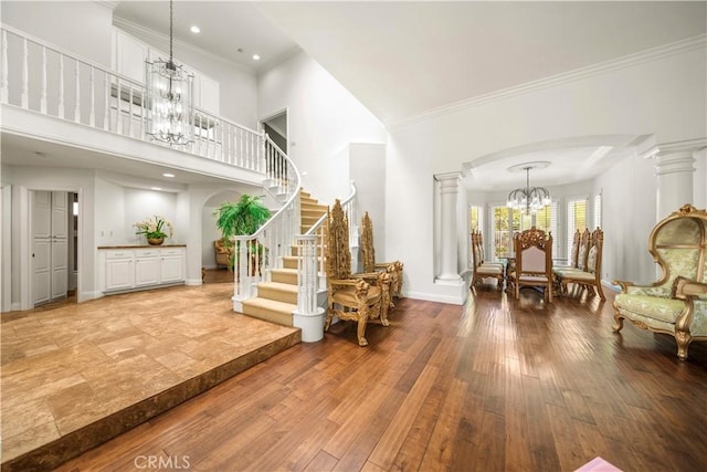 29212 Dean St, Laguna Niguel, CA 92677 - foyer with a chandelier, arched walkways, decorative columns, ornamental molding, and a high ceiling