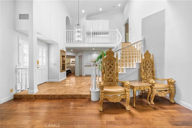 29212 Dean St, Laguna Niguel, CA 92677 - entryway with wood finished floors, a high ceiling, ornamental molding, stairs, and arched walkways