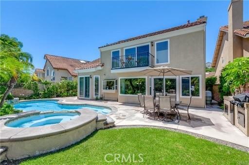 29212 Dean St, Laguna Niguel, CA 92677 - rear view of property featuring a balcony, a patio, stucco siding, and a pool with connected hot tub
