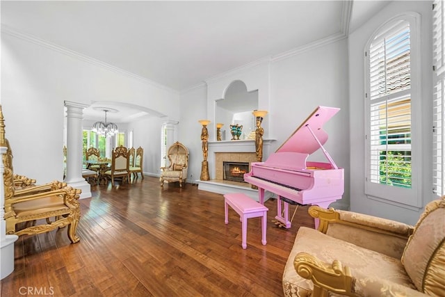29212 Dean St, Laguna Niguel, CA 92677 - sitting room featuring decorative columns, wood-type flooring, a chandelier, a tiled fireplace, and ornamental molding