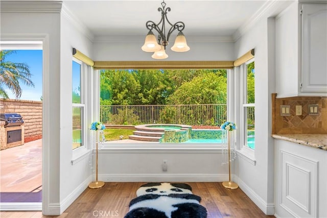 29212 Dean St, Laguna Niguel, CA 92677 - doorway featuring a chandelier, light wood-type flooring, and crown molding