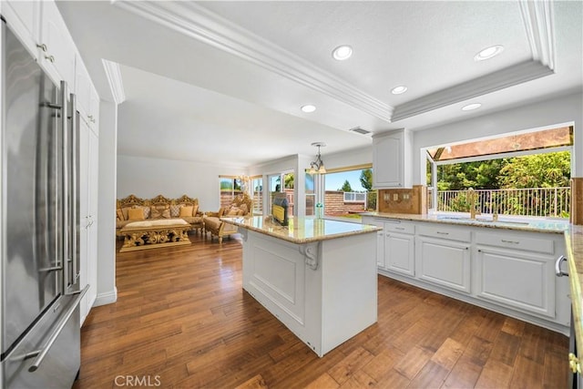 29212 Dean St, Laguna Niguel, CA 92677 - kitchen featuring high quality fridge, crown molding, white cabinets, dark wood-style floors, and light stone countertops