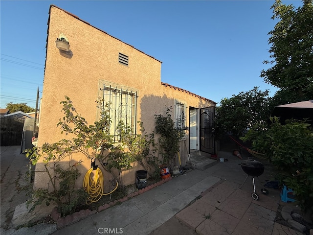 9418 Zamora Ave, Los Angeles, CA 90002 - view of side of property featuring stucco siding and a patio area