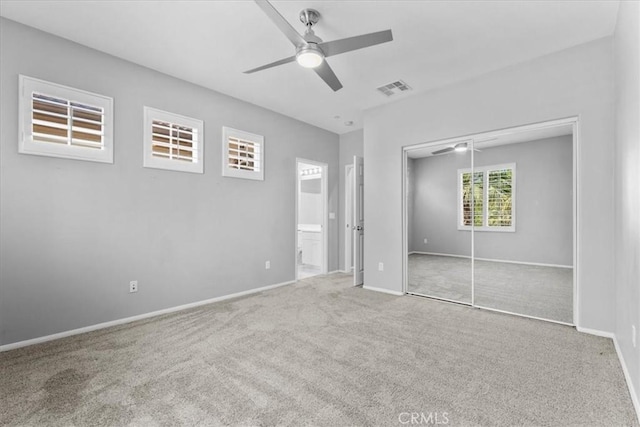26327 Iris Ave Unit C, Moreno Valley, CA 92555 - unfurnished bedroom with carpet flooring, a closet, connected bathroom, and a ceiling fan