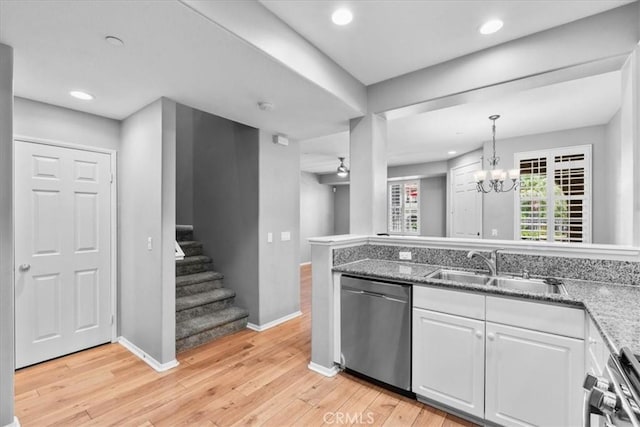 26327 Iris Ave Unit C, Moreno Valley, CA 92555 - kitchen with appliances with stainless steel finishes, light wood-style flooring, recessed lighting, white cabinets, and a chandelier