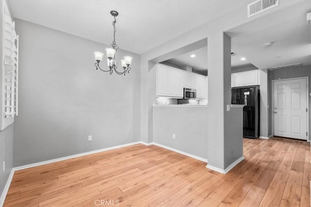 26327 Iris Ave Unit C, Moreno Valley, CA 92555 - unfurnished dining area with a chandelier, light wood-style flooring, and recessed lighting