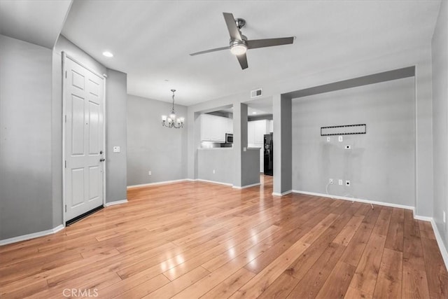 26327 Iris Ave Unit C, Moreno Valley, CA 92555 - unfurnished living room with ceiling fan, a chandelier, light wood-style floors, and recessed lighting