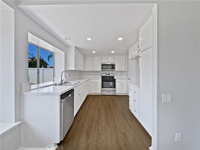 29923 Corte Cruzada, Menifee, CA 92584 - kitchen featuring stainless steel appliances, dark wood finished floors, white cabinetry, light countertops, and recessed lighting