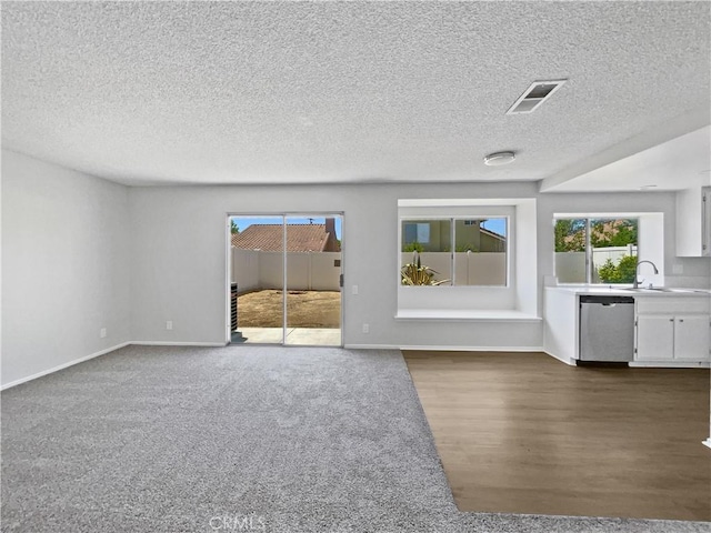 29923 Corte Cruzada, Menifee, CA 92584 - unfurnished living room with healthy amount of natural light, a textured ceiling, and dark wood-style flooring