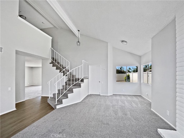 29923 Corte Cruzada, Menifee, CA 92584 - unfurnished living room with stairway, carpet flooring, high vaulted ceiling, a textured ceiling, and wood finished floors