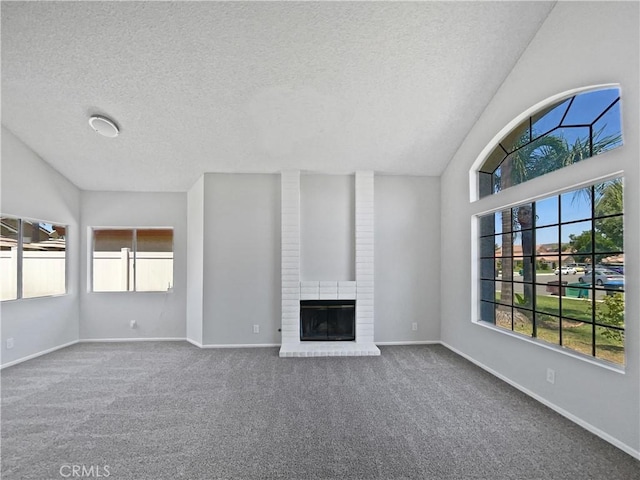 29923 Corte Cruzada, Menifee, CA 92584 - unfurnished living room featuring plenty of natural light, a textured ceiling, carpet flooring, vaulted ceiling, and a brick fireplace