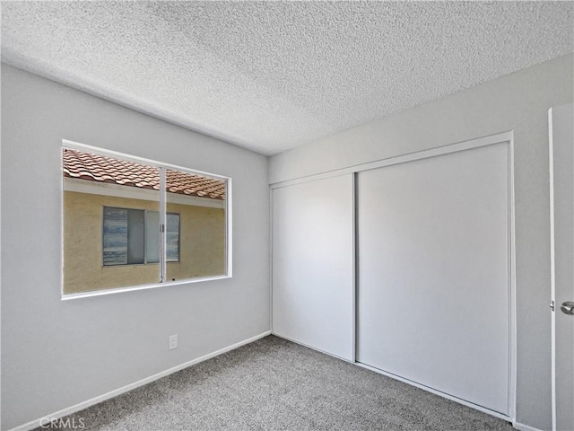 29923 Corte Cruzada, Menifee, CA 92584 - unfurnished bedroom with a textured ceiling, carpet flooring, and a closet
