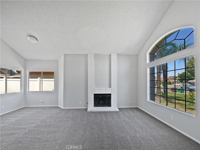 29923 Corte Cruzada, Menifee, CA 92584 - unfurnished living room with plenty of natural light, a textured ceiling, vaulted ceiling, carpet flooring, and a fireplace