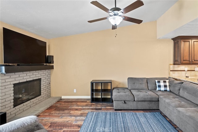 3197 Bexfield Ct, Riverside, CA 92503 - living area featuring dark wood-style flooring, ceiling fan, and a fireplace