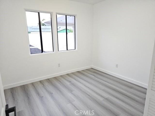 7927 Chastain Pl, Reseda, CA 91335 - unfurnished room featuring wood finished floors and baseboards