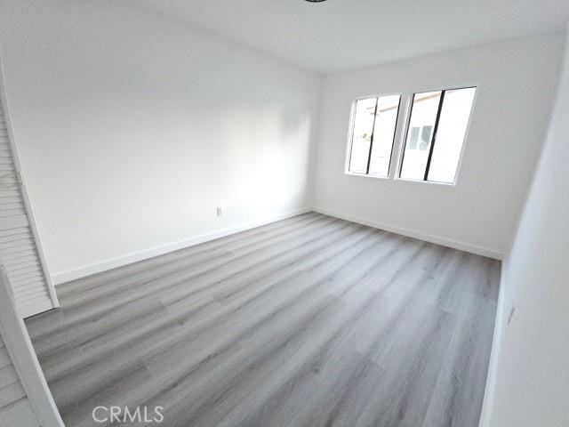 7927 Chastain Pl, Reseda, CA 91335 - unfurnished room featuring wood finished floors and baseboards