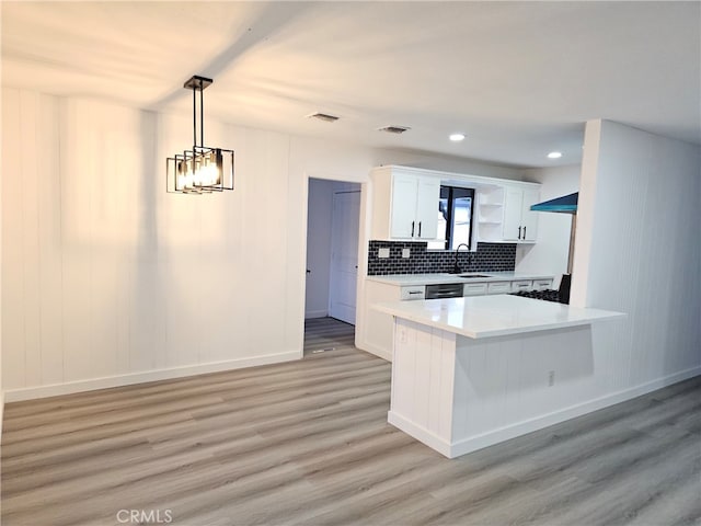 7927 Chastain Pl, Reseda, CA 91335 - kitchen featuring light wood finished floors, white cabinetry, open shelves, light countertops, and decorative backsplash