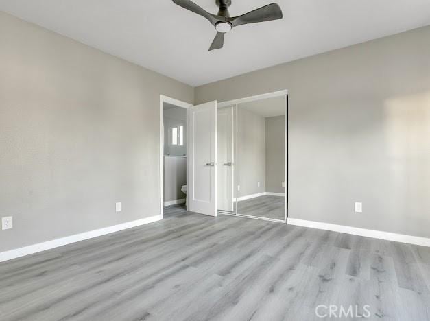 1438 W 69th St, Los Angeles, CA 90047 - unfurnished bedroom with wood finished floors, a closet, and a ceiling fan