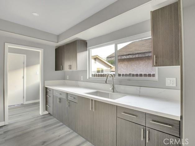 1438 W 69th St, Los Angeles, CA 90047 - kitchen featuring light wood finished floors, light countertops, and gray cabinets