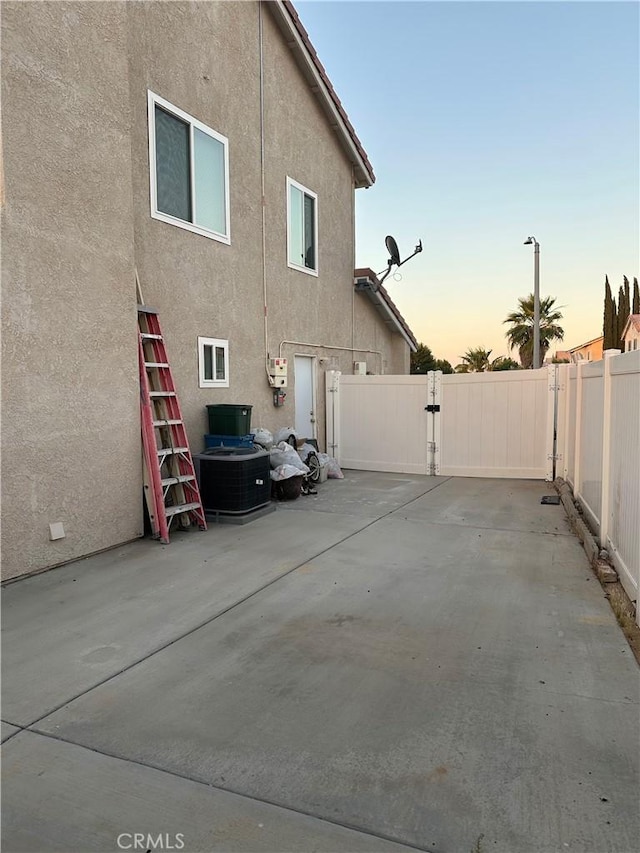 15654 Enfield Dr, Victorville, CA 92394 - view of property exterior featuring stucco siding, a patio, and a gate