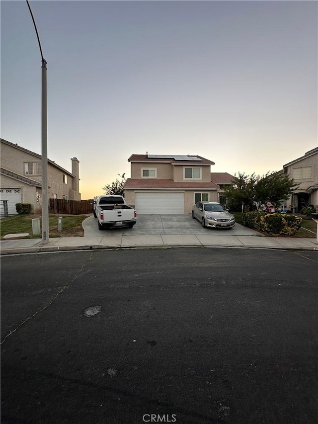 15654 Enfield Dr, Victorville, CA 92394 - traditional-style home with concrete driveway, stucco siding, and a garage