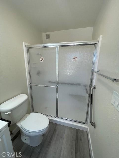 28838 Snead Dr, Menifee, CA 92586 - bathroom with wood finished floors, vanity, and a shower stall
