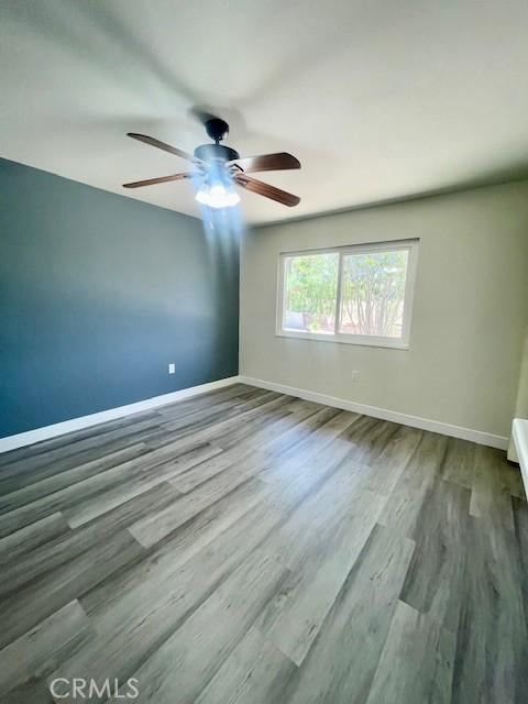 28838 Snead Dr, Menifee, CA 92586 - empty room with ceiling fan and wood finished floors
